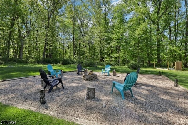 view of home's community with a fire pit and a yard