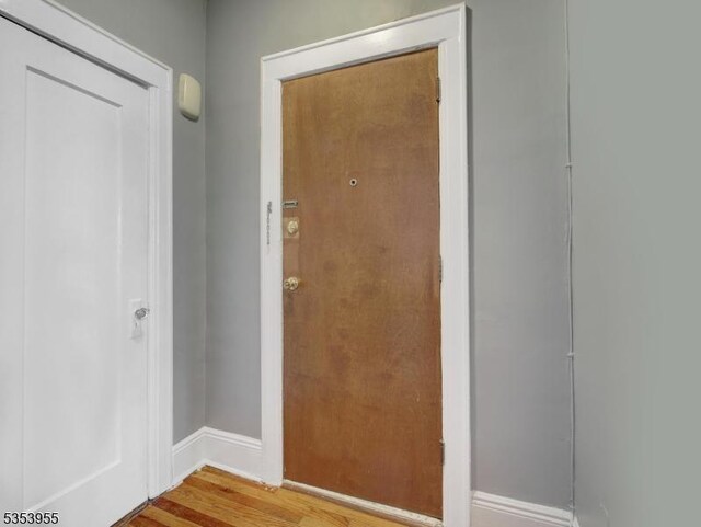 entryway featuring baseboards and wood finished floors