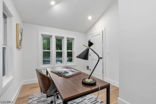 office area featuring light wood-type flooring, baseboards, lofted ceiling, and recessed lighting