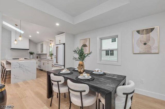 dining room featuring light wood-style flooring, recessed lighting, and baseboards