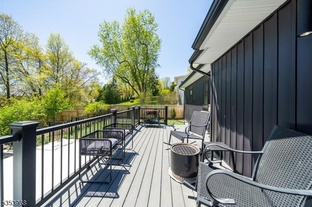 wooden terrace with a fenced backyard