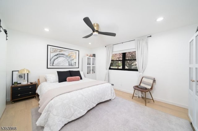 bedroom featuring a ceiling fan, recessed lighting, and wood finished floors