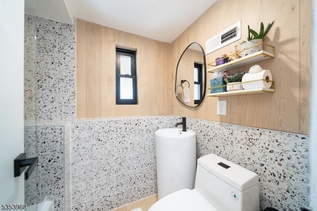 full bath featuring toilet and visible vents