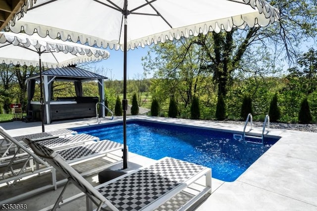 outdoor pool with a patio, a gazebo, and a hot tub