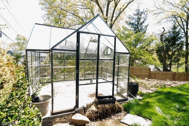 view of greenhouse with fence