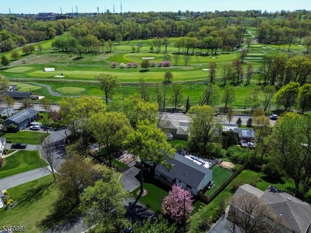 drone / aerial view featuring view of golf course and a residential view