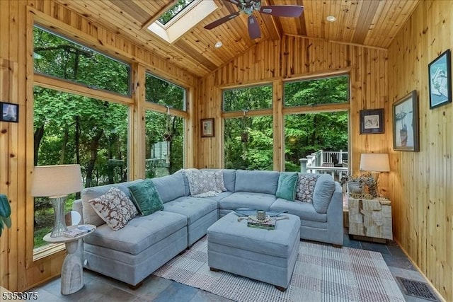 sunroom with healthy amount of natural light, vaulted ceiling, and a skylight
