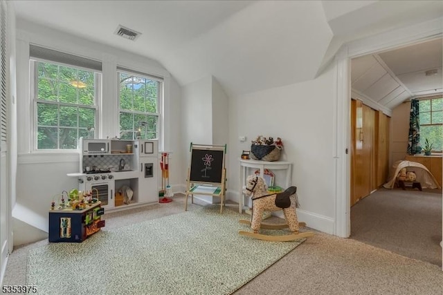 recreation room with lofted ceiling, carpet floors, and baseboards