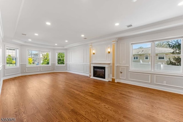 1537 Franklin St, Clark Twp, NJ 07066 - unfurnished living room featuring a decorative wall, ornamental molding, plenty of natural light, wood finished floors, and a glass covered fireplace