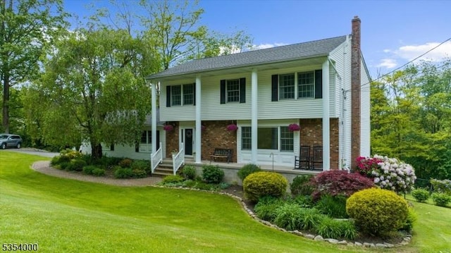 45 Marble Hill Rd, Liberty Twp, NJ 07838 - view of front facade featuring a front yard, a chimney, brick siding, and covered porch