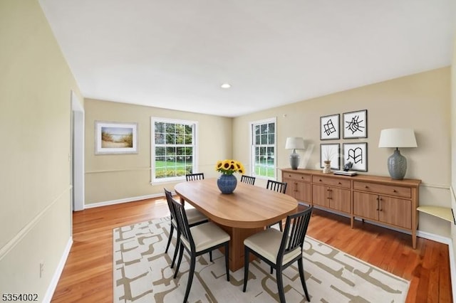 dining area featuring recessed lighting, baseboards, and light wood finished floors