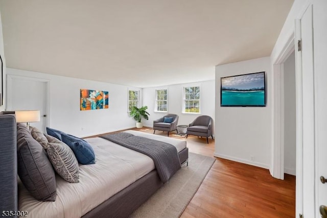 bedroom with baseboards and light wood-style flooring
