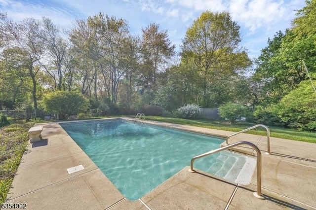 pool with fence and a patio area