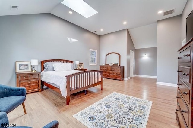 bedroom featuring visible vents, baseboards, a skylight, and light wood-type flooring