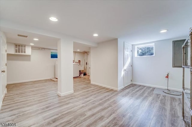 below grade area with light wood-type flooring, recessed lighting, baseboards, and visible vents