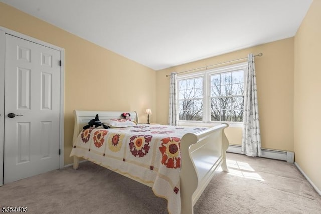 carpeted bedroom with baseboards and a baseboard heating unit