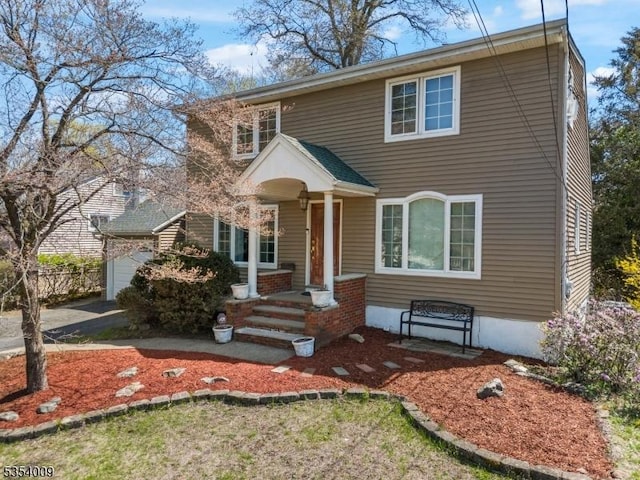 view of front of property featuring a garage and aphalt driveway