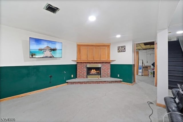 unfurnished living room featuring baseboards, recessed lighting, a brick fireplace, and visible vents