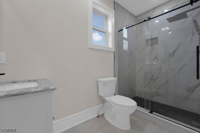 bathroom with baseboards, a marble finish shower, toilet, and vanity