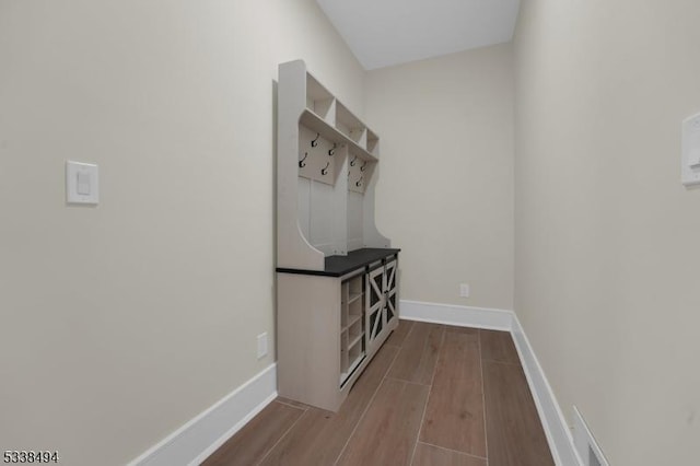 interior space with baseboards and wood finished floors