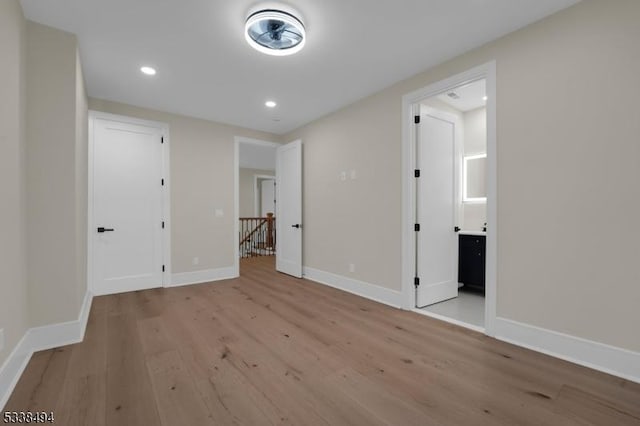interior space with baseboards, recessed lighting, and wood finished floors