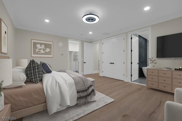 bedroom with baseboards, light wood-type flooring, and recessed lighting