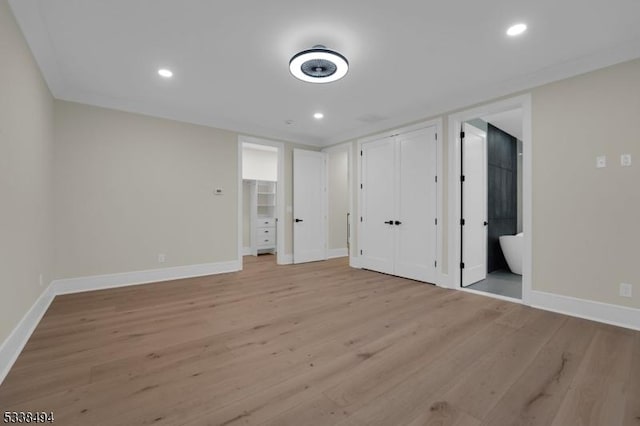 unfurnished bedroom featuring light wood-type flooring, recessed lighting, and baseboards