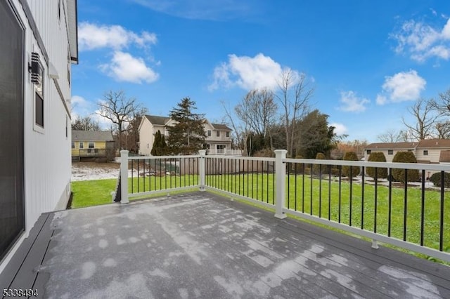 wooden deck featuring a lawn and a residential view