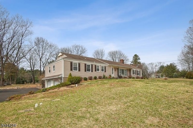 11 Mountain View Dr, Chester Twp, NJ 07930 - view of front of house with a front yard, driveway, a chimney, and a garage