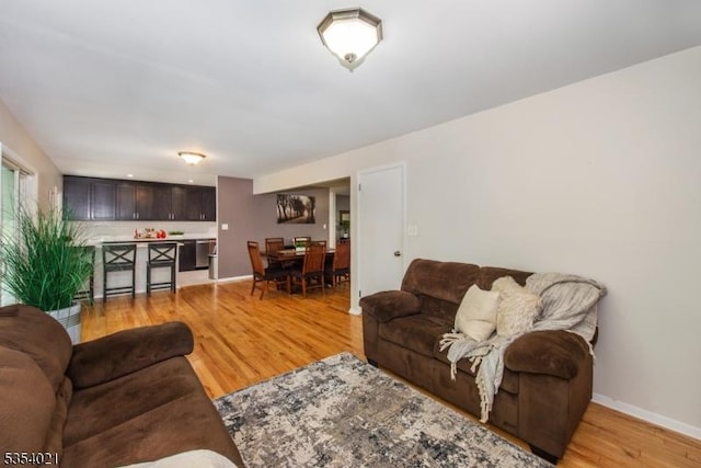 living room featuring light wood-type flooring and baseboards