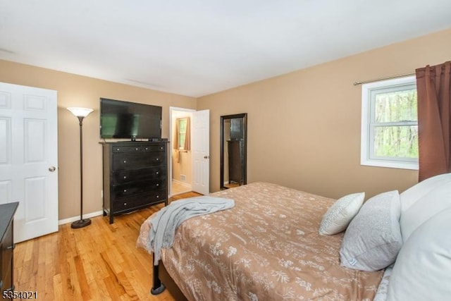 bedroom with light wood-style floors and baseboards