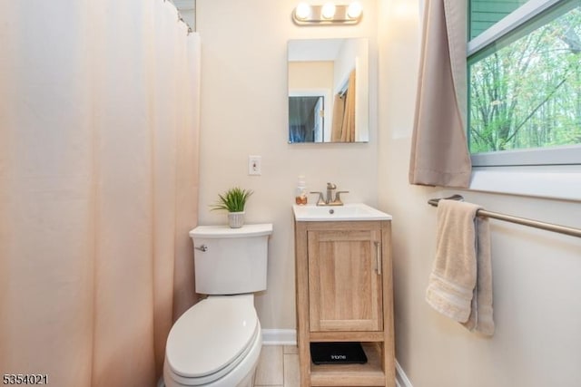 full bathroom with toilet and vanity