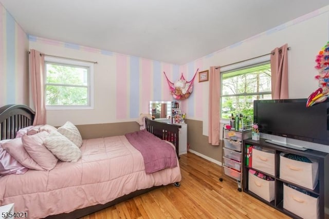 bedroom featuring baseboards and light wood-style floors