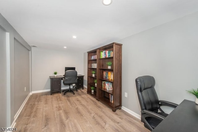 office space featuring recessed lighting, light wood finished floors, and baseboards