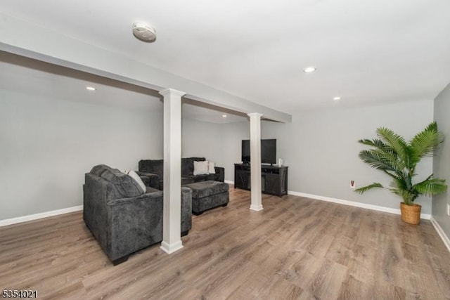 living area with recessed lighting, baseboards, and light wood-type flooring