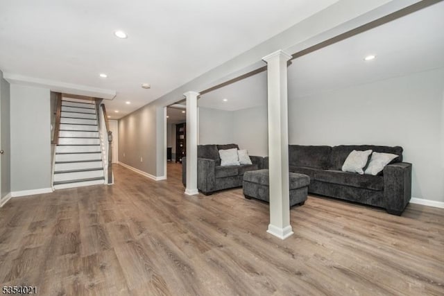 living room featuring baseboards, recessed lighting, wood finished floors, and stairway