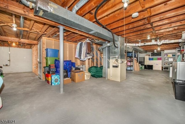 unfinished basement featuring heating unit