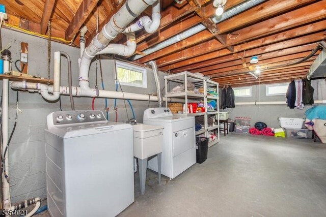 laundry area featuring a sink, laundry area, and washer and clothes dryer