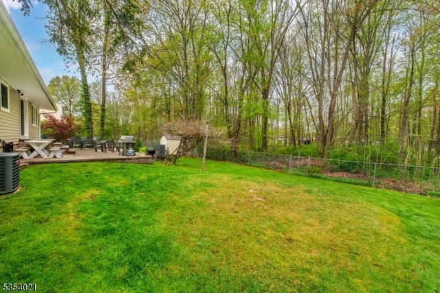 view of yard featuring fence, central air condition unit, and a patio area