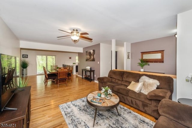 living room featuring light wood-style floors and ceiling fan