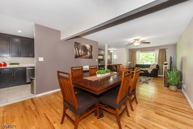 dining area featuring light wood-type flooring, a ceiling fan, and baseboards