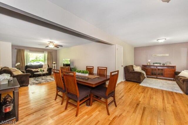 dining room with a ceiling fan and light wood-style flooring