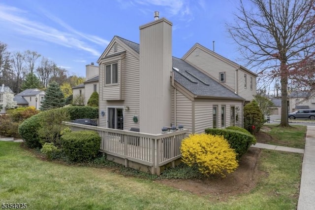 3 F Somerset Hills Ct Unit 3F, Bernardsville Boro, NJ 07924 - view of property exterior with a chimney, a wooden deck, a yard, and roof with shingles