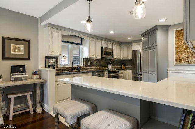 3 F Somerset Hills Ct Unit 3F, Bernardsville Boro, NJ 07924 - kitchen featuring appliances with stainless steel finishes, decorative backsplash, a kitchen breakfast bar, dark wood-style floors, and hanging light fixtures