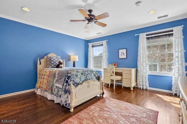 bedroom featuring crown molding, baseboards, and wood finished floors