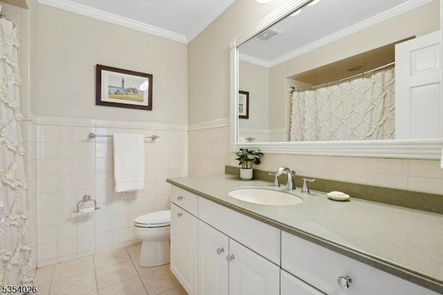 bathroom with tile patterned flooring, vanity, toilet, tile walls, and ornamental molding