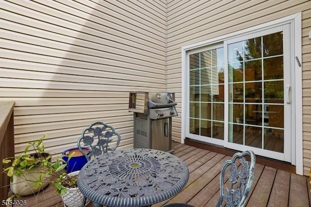 wooden deck featuring a grill