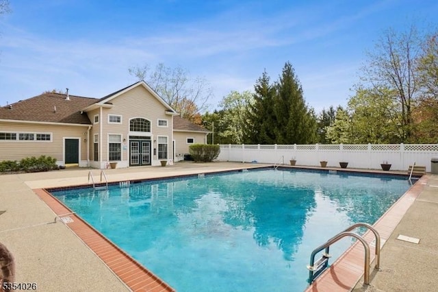 view of pool featuring a fenced in pool, a patio area, fence, and french doors