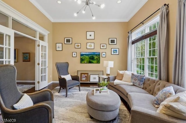 living area with crown molding, a chandelier, french doors, baseboards, and wood finished floors