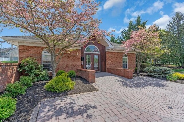view of front of home with brick siding and french doors